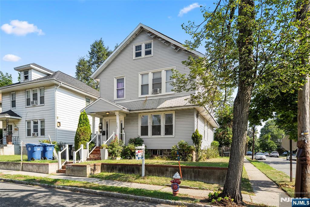 267 Hirliman Road Englewood, NJ 07631 - Photo 2 of 16 a front view of a house with garden and trees