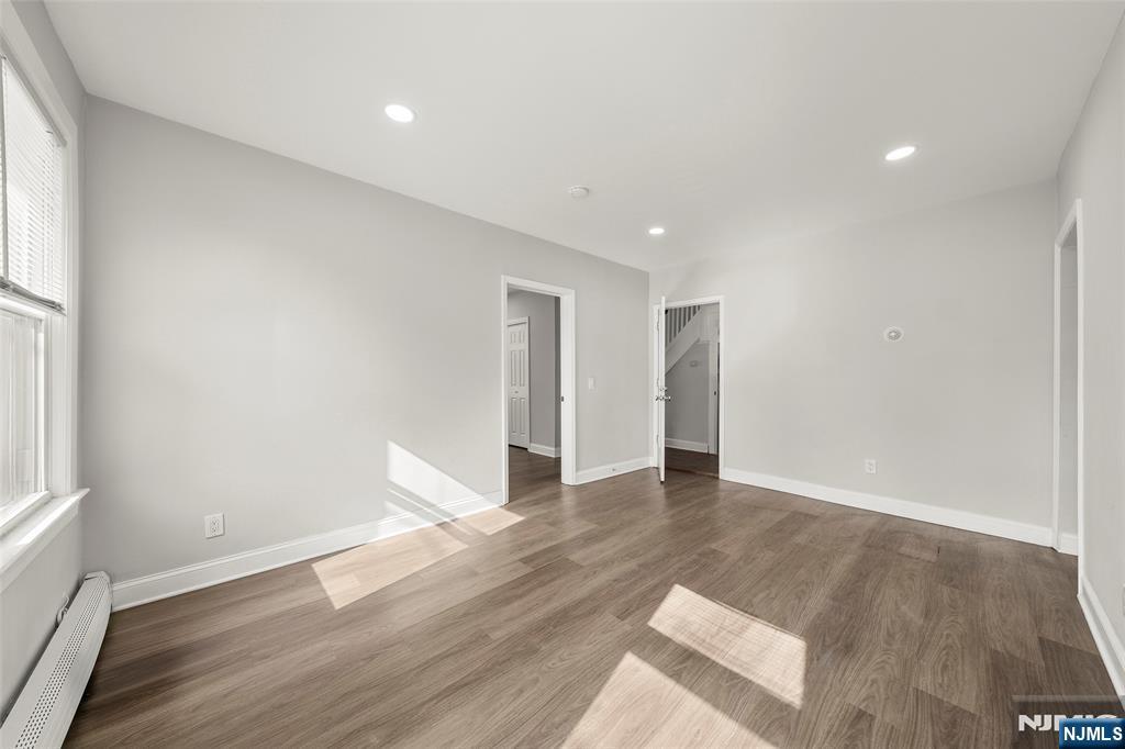 267 Hirliman Road Englewood, NJ 07631 - Photo 4 of 16 a view of an empty room with wooden floor and a window