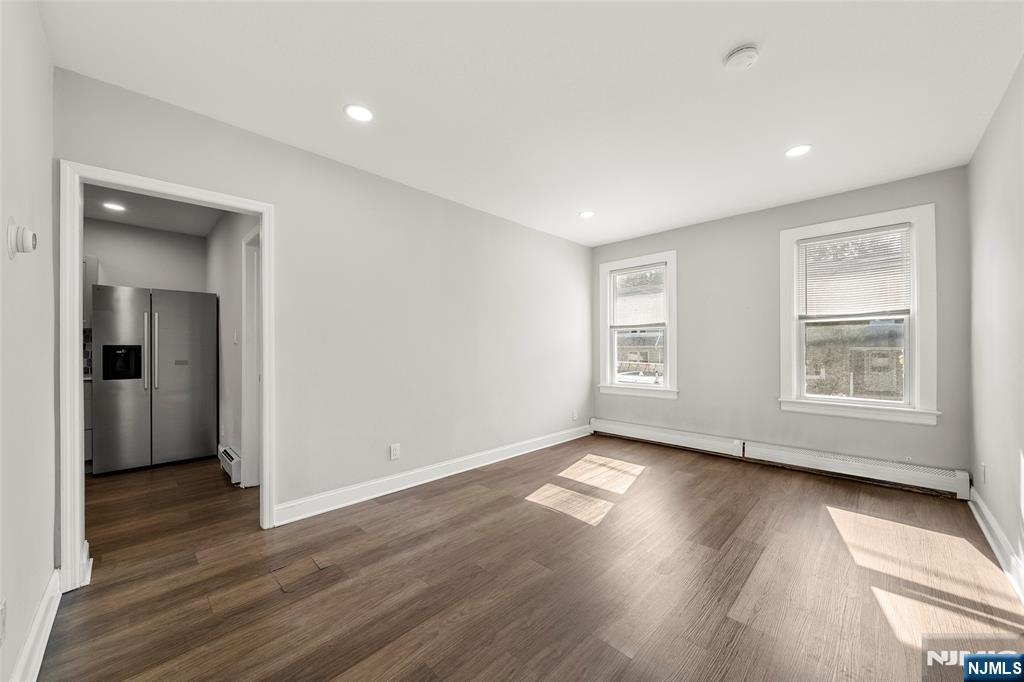 267 Hirliman Road Englewood, NJ 07631 - Photo 5 of 16 a view of an empty room with wooden floor and a window