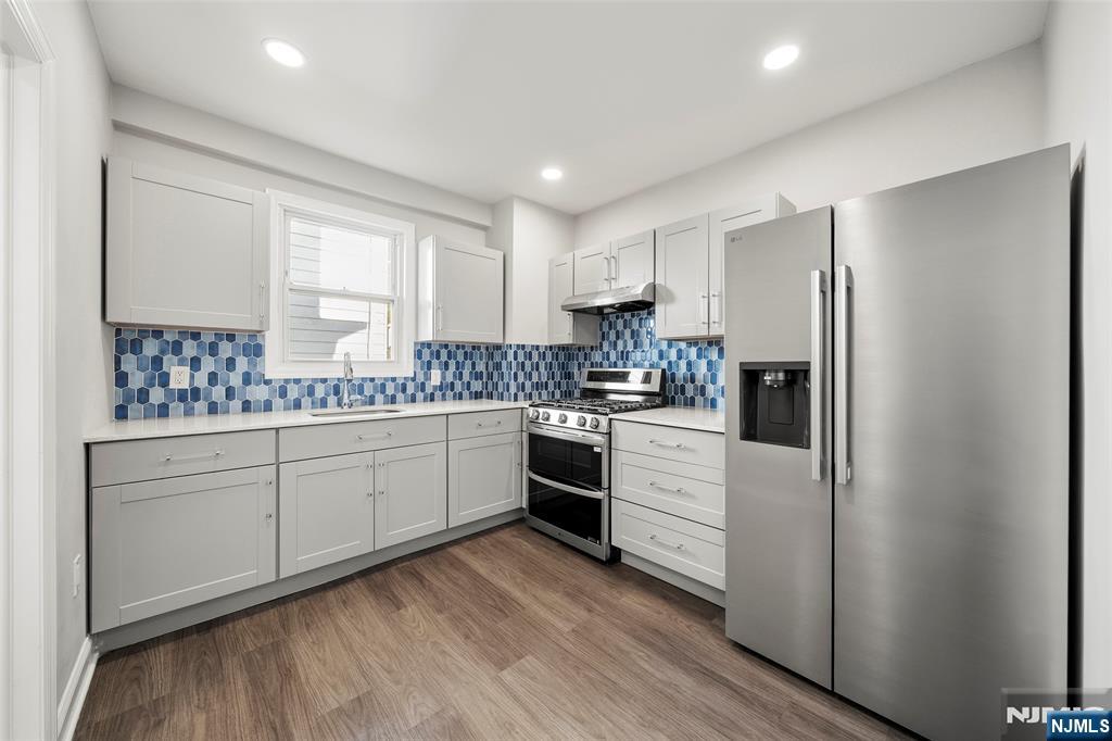 267 Hirliman Road Englewood, NJ 07631 - Photo 7 of 16 a kitchen with white cabinets and white appliances