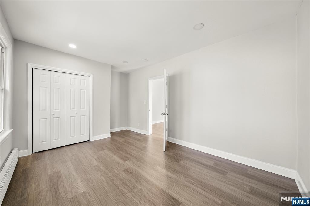 267 Hirliman Road Englewood, NJ 07631 - Photo 10 of 16 a view of an empty room with wooden floor