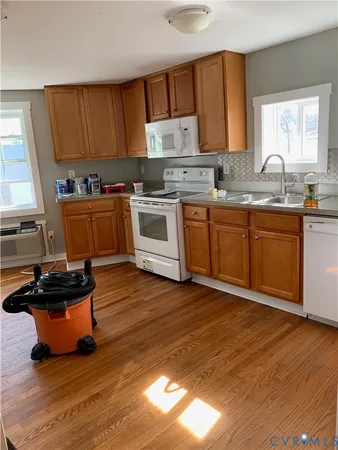 a kitchen with wooden floors and sink