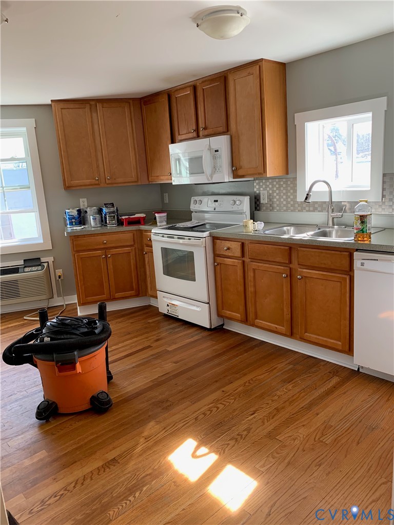 1002 Main Street Dillwyn, VA 23936 - Photo 4 of 16 a kitchen with wooden floors and sink