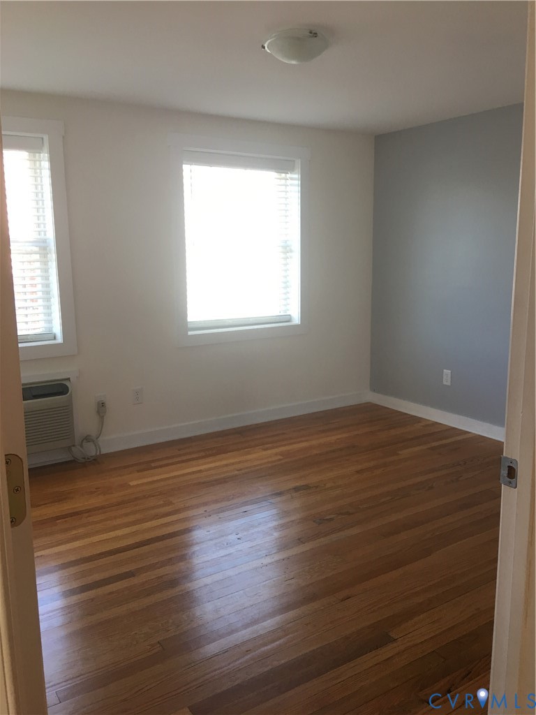 1002 Main Street Dillwyn, VA 23936 - Photo 6 of 16 an empty room with wooden floor and windows
