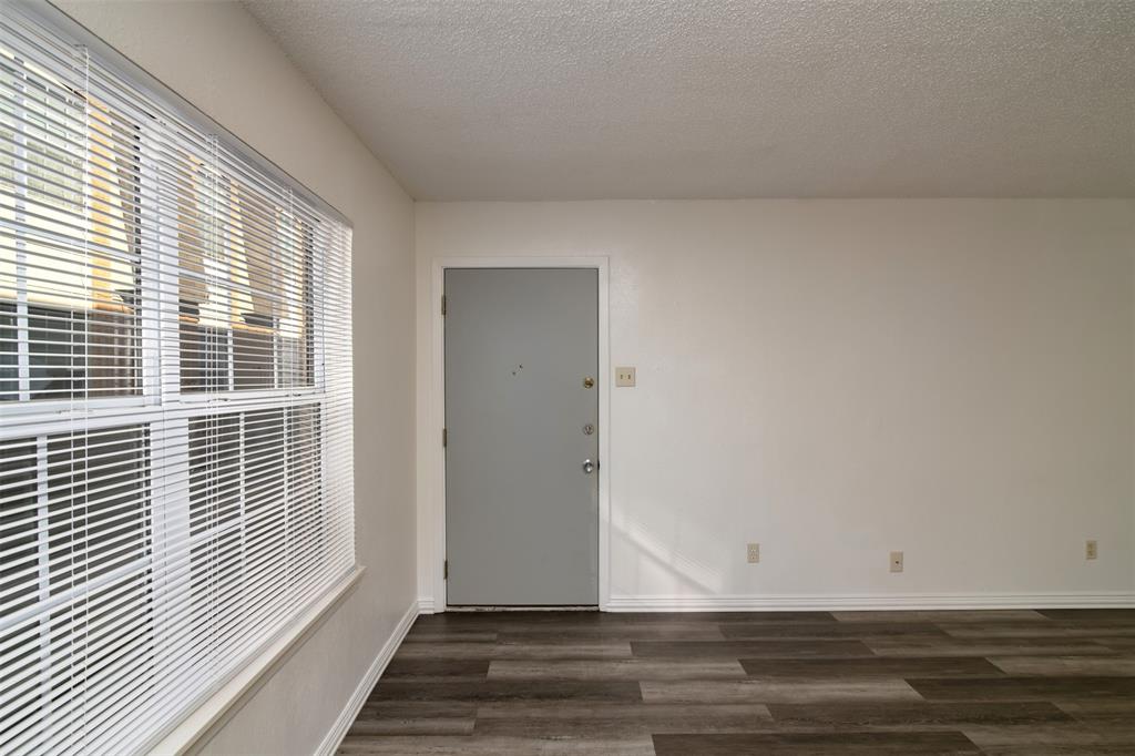 7064 Glenview Drive, Unit 92 North Richland Hills, TX 76180 - Photo 6 of 11 a view of wooden floor and brick walls