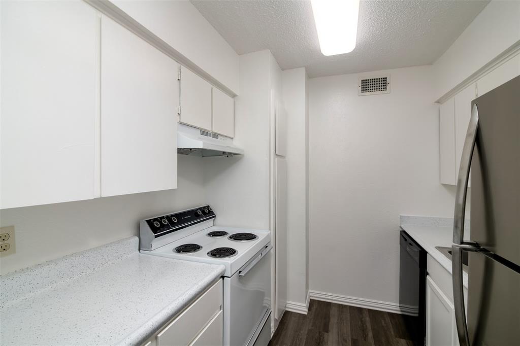 7064 Glenview Drive, Unit 92 North Richland Hills, TX 76180 - Photo 8 of 11 a kitchen with stainless steel appliances a refrigerator a stove and a more cabinets