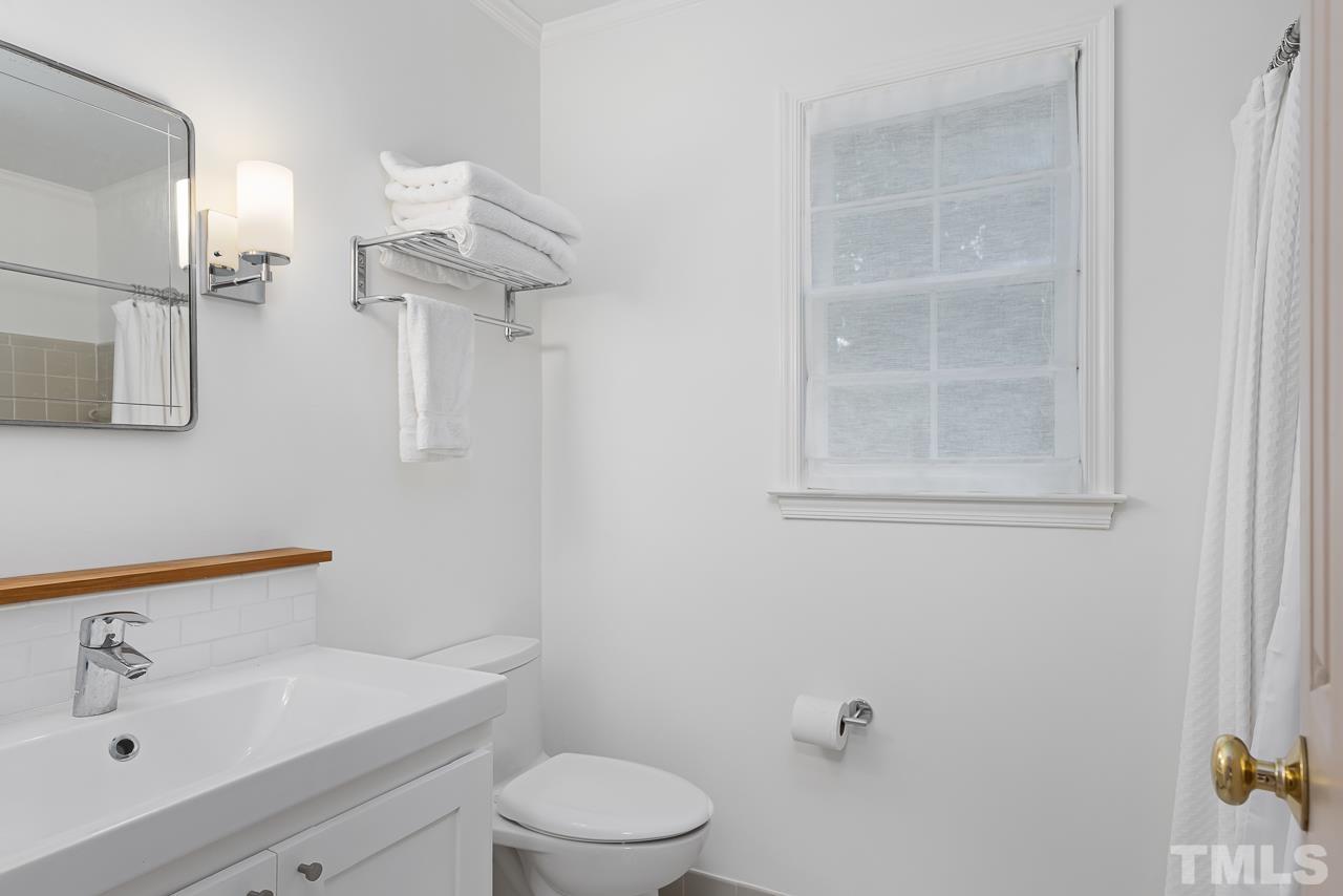 7309 Glendower Road Raleigh, NC 27613 - Photo 11 of 19 a bathroom with a sink a toilet and shower