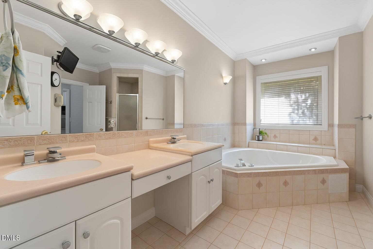 5870 Hoyt Road Middlesex, NC 27557 - Photo 16 of 33 a bathroom with a sink double vanity mirror and a bathtub
