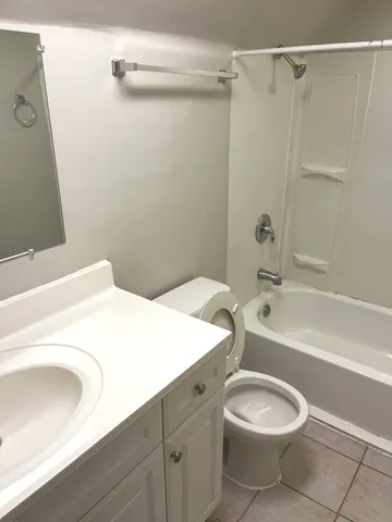 a bathroom with a sink a toilet and bathtub