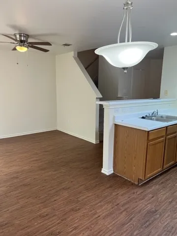 a view of a room with wooden floor