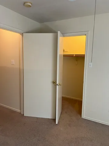 a view of an empty room with a closet