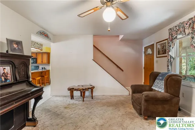 a kitchen with stainless steel appliances granite countertop a stove a refrigerator a sink a dining table and chairs with wooden floor