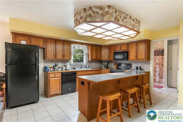 a kitchen with stainless steel appliances granite countertop a sink and a stove