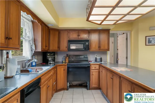 a kitchen with lots of counter top space and refrigerator