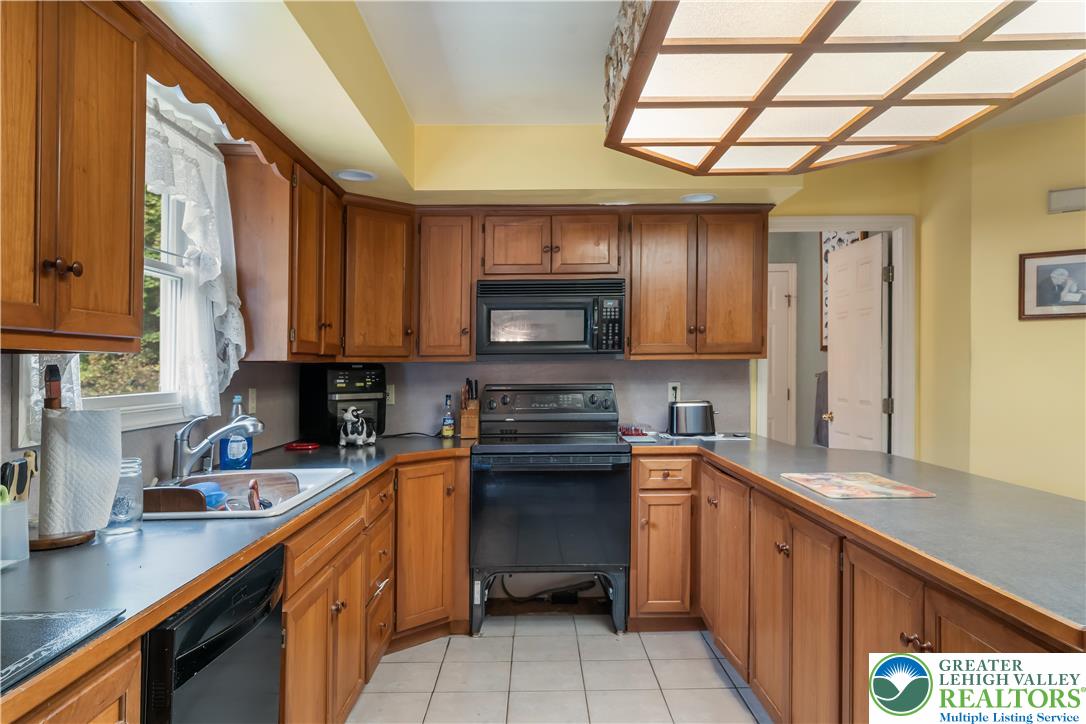 390 Long Lane Road Walnutport, PA 18088 - Photo 15 of 56 a kitchen with stainless steel appliances granite countertop a sink and a stove