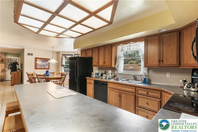 a view of a dining room with furniture and a large window