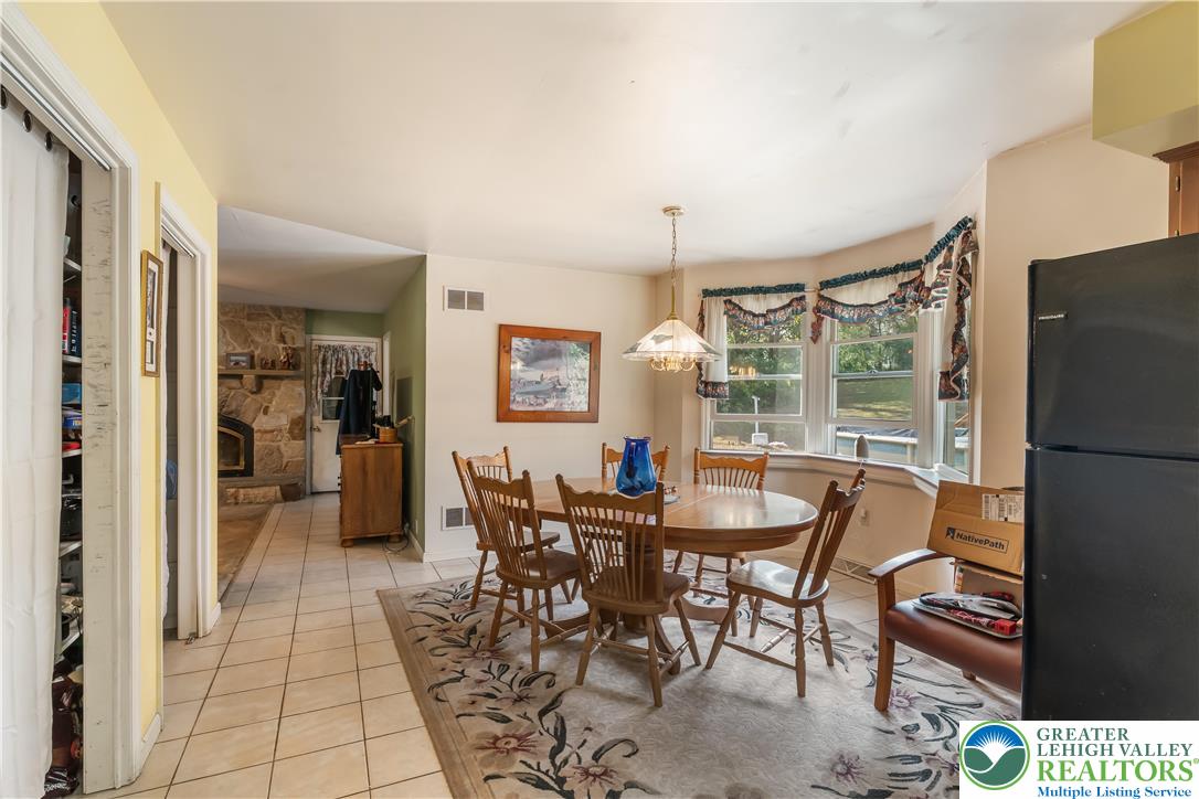 390 Long Lane Road Walnutport, PA 18088 - Photo 19 of 56 a view of a dining room with furniture and a large window