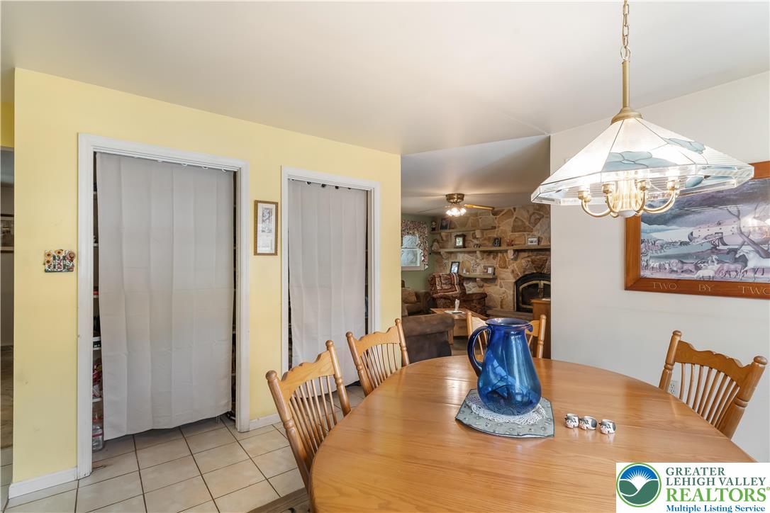 390 Long Lane Road Walnutport, PA 18088 - Photo 21 of 56 a dining room with wooden floor table and chairs