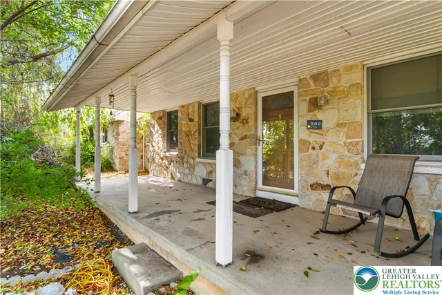 a view of a patio with table and chairs and potted plants