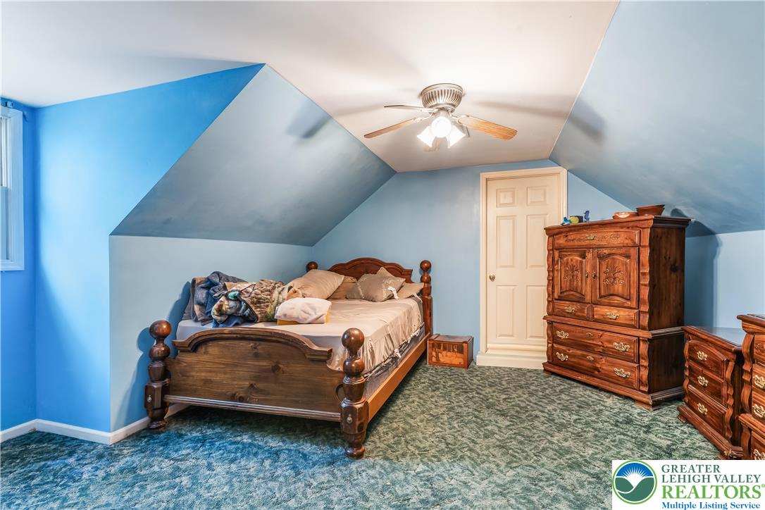 390 Long Lane Road Walnutport, PA 18088 - Photo 32 of 56 a bedroom with a bed and a chandelier
