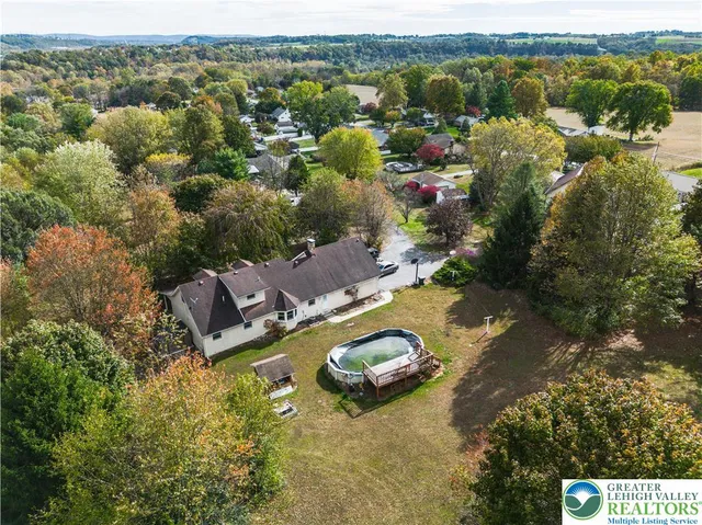 an aerial view of residential houses with outdoor space