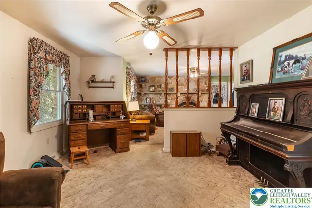 a living room with furniture kitchen view and a wooden floor