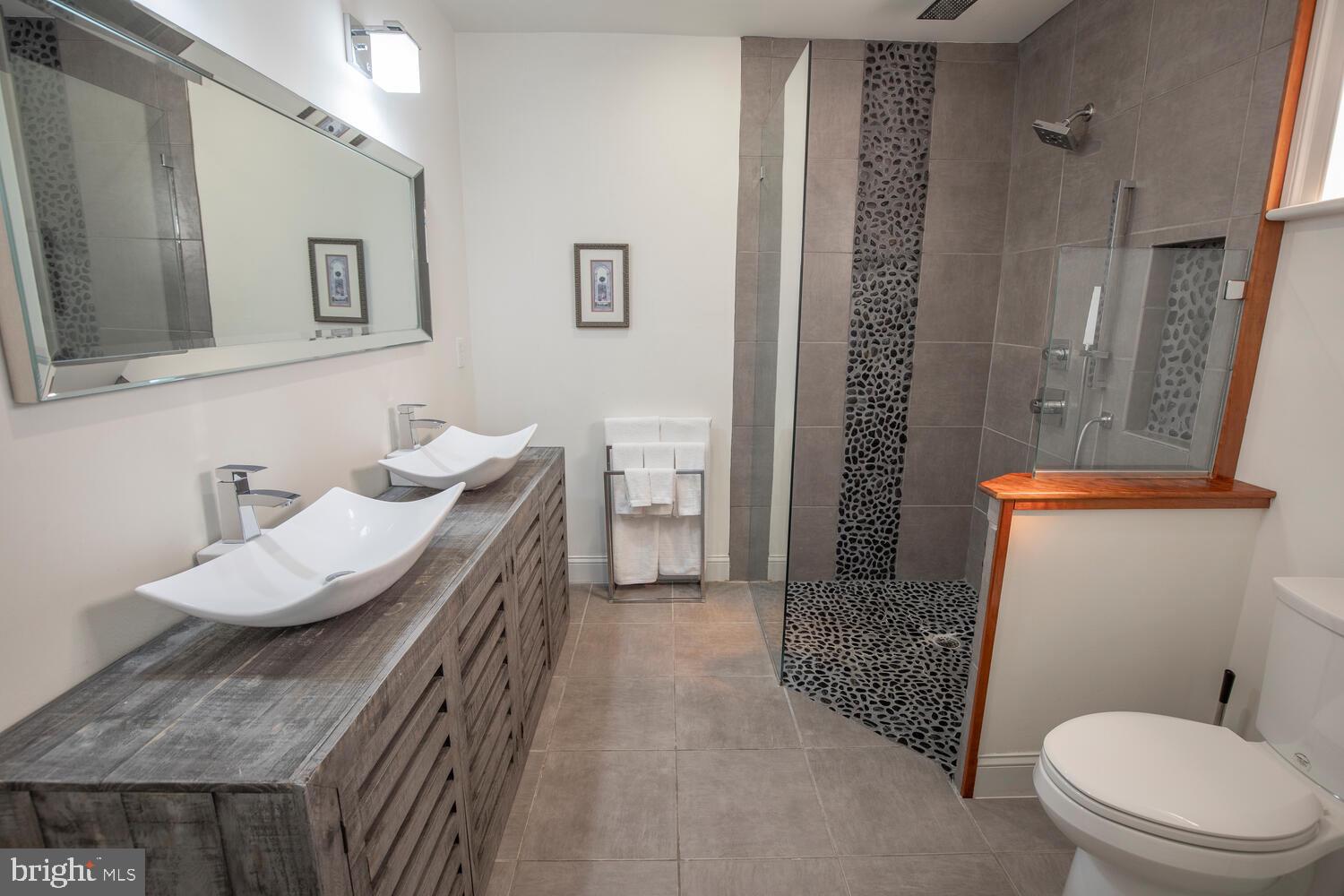 121 Cottage Street Doylestown, PA 18901 - Photo 27 of 46 a bathroom with a granite countertop sink a toilet a mirror and shower