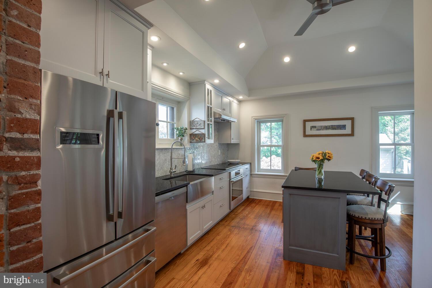 121 Cottage Street Doylestown, PA 18901 - Photo 10 of 46 a kitchen with granite countertop kitchen island stainless steel appliances a refrigerator a stove a sink a dining table and chairs with wooden floor