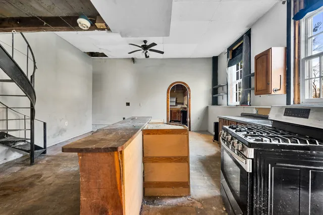 a view of living room kitchen with a sink and dishwasher