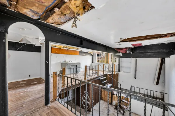 a view of balcony with wooden floor and stairs