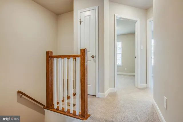 an empty room with closet and a ceiling fan