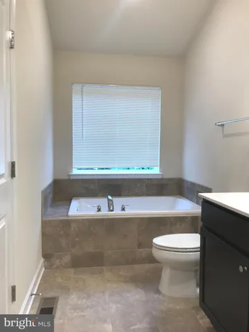 a bathroom with a shower sink and mirror