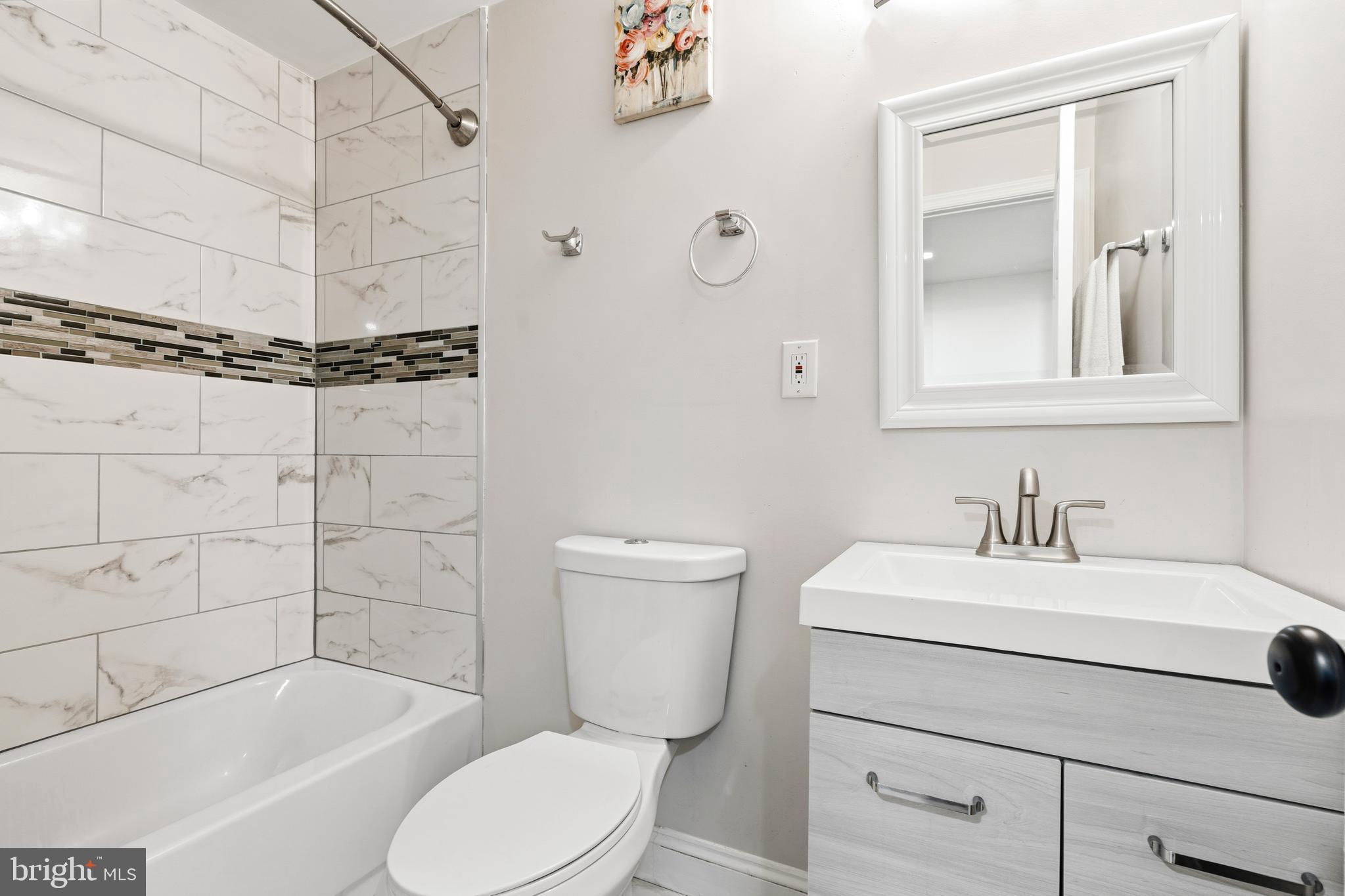 552 48th Street Baltimore, MD 21224 - Photo 22 of 29 a bathroom with a sink toilet and shower
