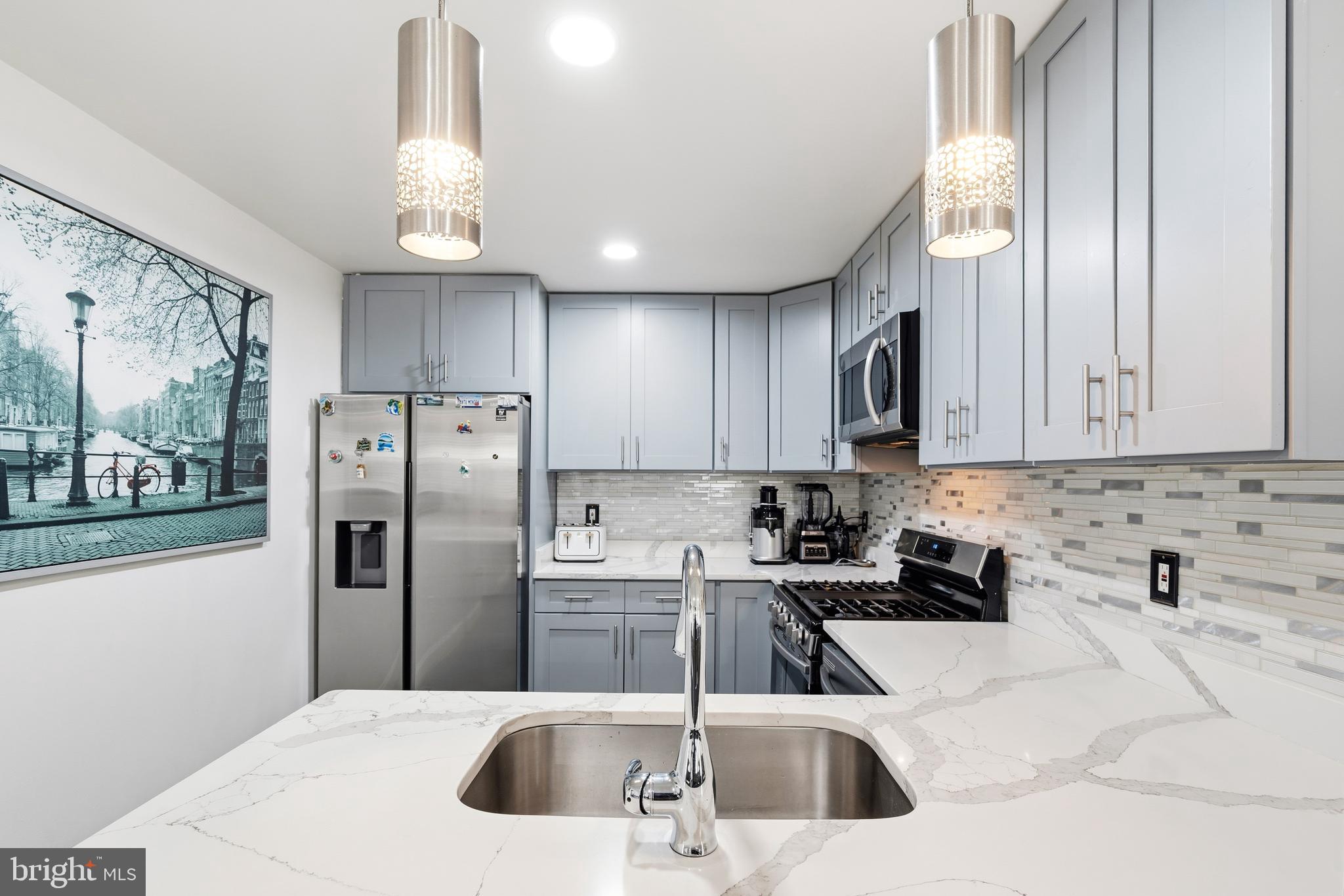 552 48th Street Baltimore, MD 21224 - Photo 10 of 29 a kitchen with stainless steel appliances granite countertop a refrigerator sink and cabinets