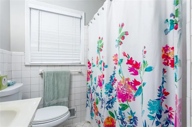 a bathroom with a sink a mirror and a shower curtain