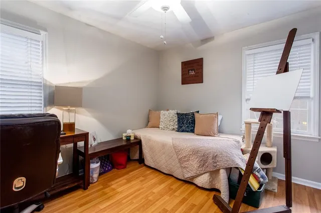 a bedroom with a bed and wooden floor