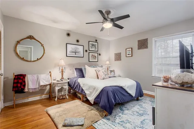 a bedroom with a bed mirror and a window