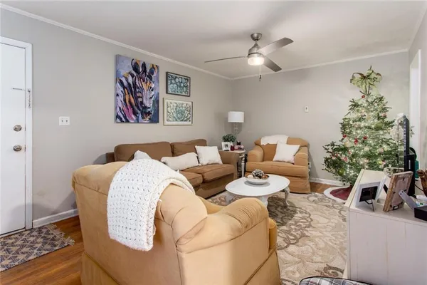 a living room with furniture and a chandelier