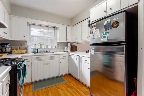 a kitchen with stainless steel appliances granite countertop a sink and cabinets
