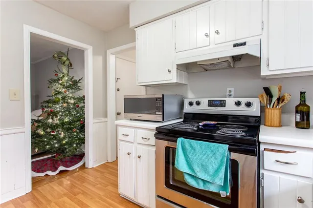 a kitchen with stainless steel appliances a stove a microwave and cabinets