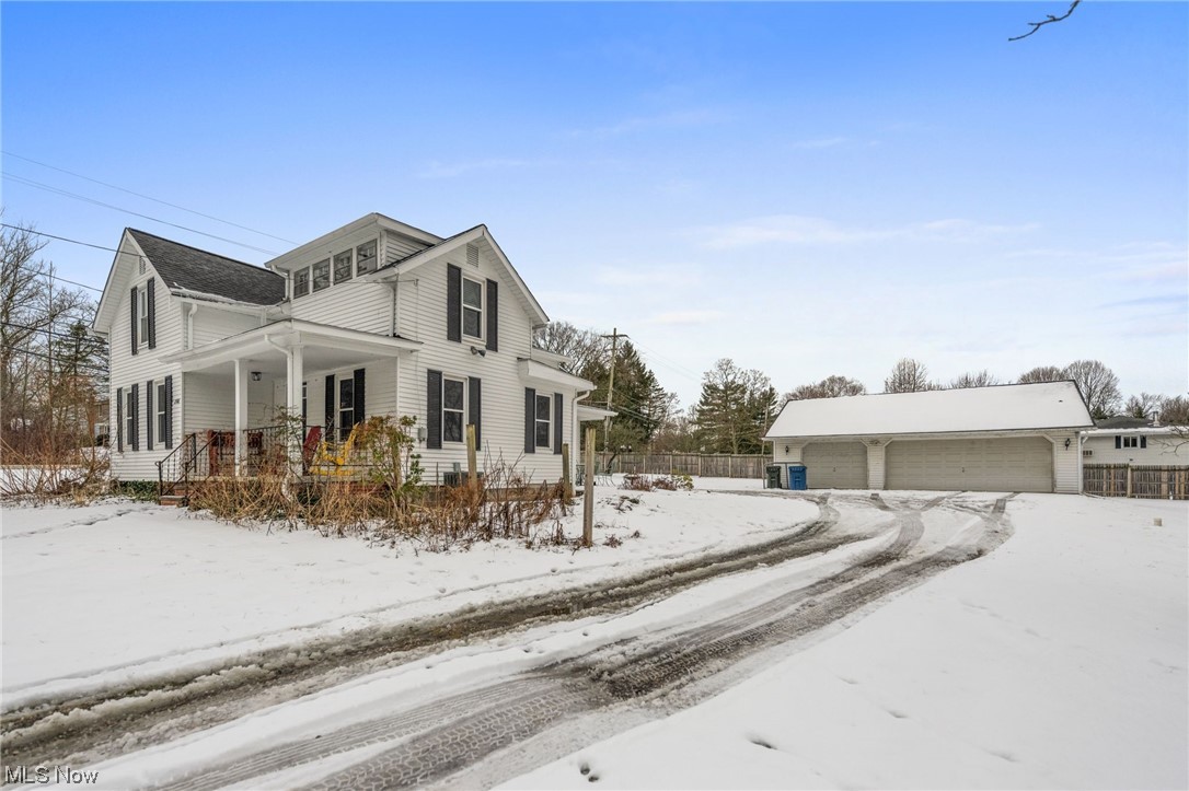 2986 Worrell Road Willoughby, OH 44094 - Photo 3 of 36 Snow covered property featuring a garage and covered porch