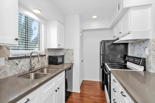 a kitchen that has a sink and a stove