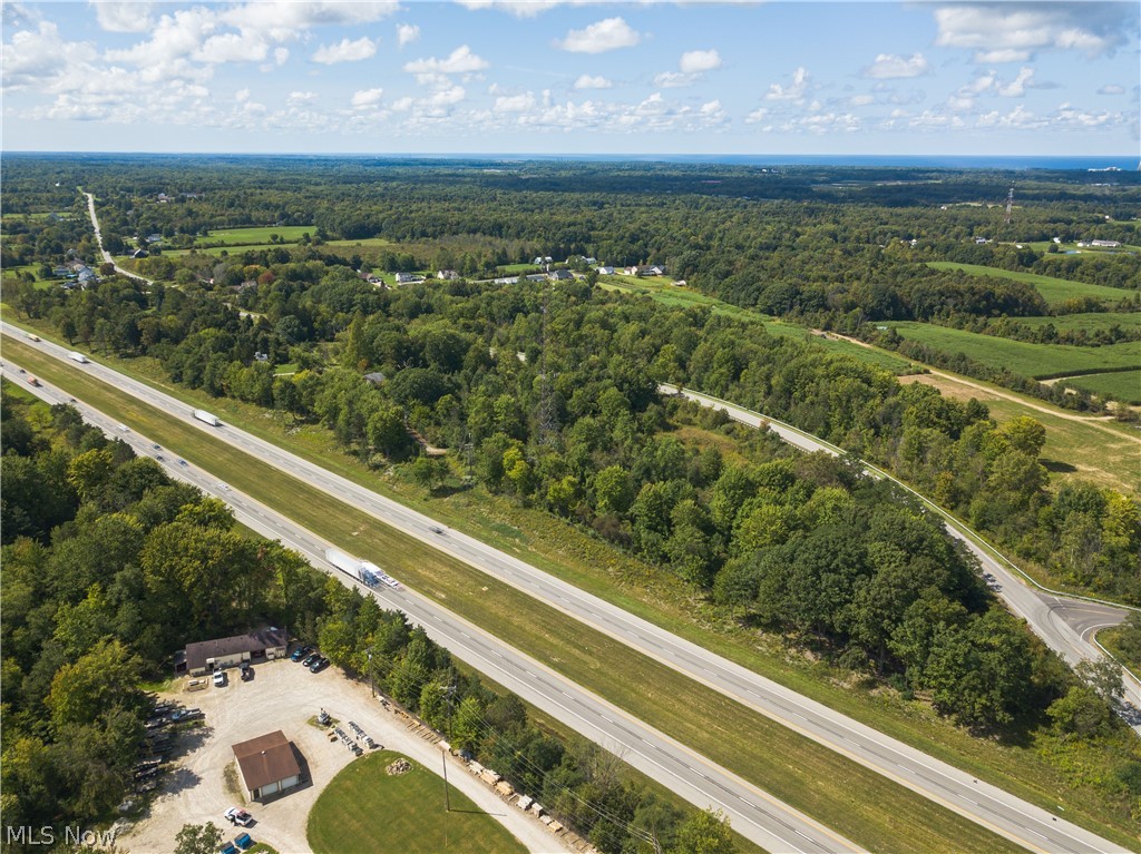 River Road Madison, OH 44057 - Photo 3 of 9 Aerial view looking west along the I-90 corridor showing the parcel's wooded footprint.