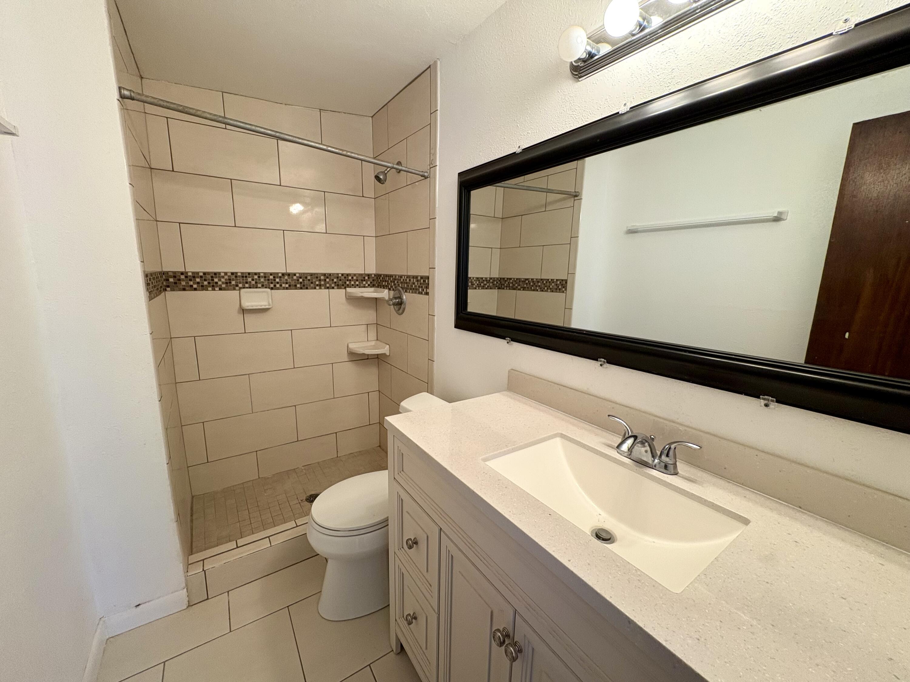 4618 44th Street Lubbock, TX 79414 - Photo 15 of 21 a bathroom with a sink toilet and shower