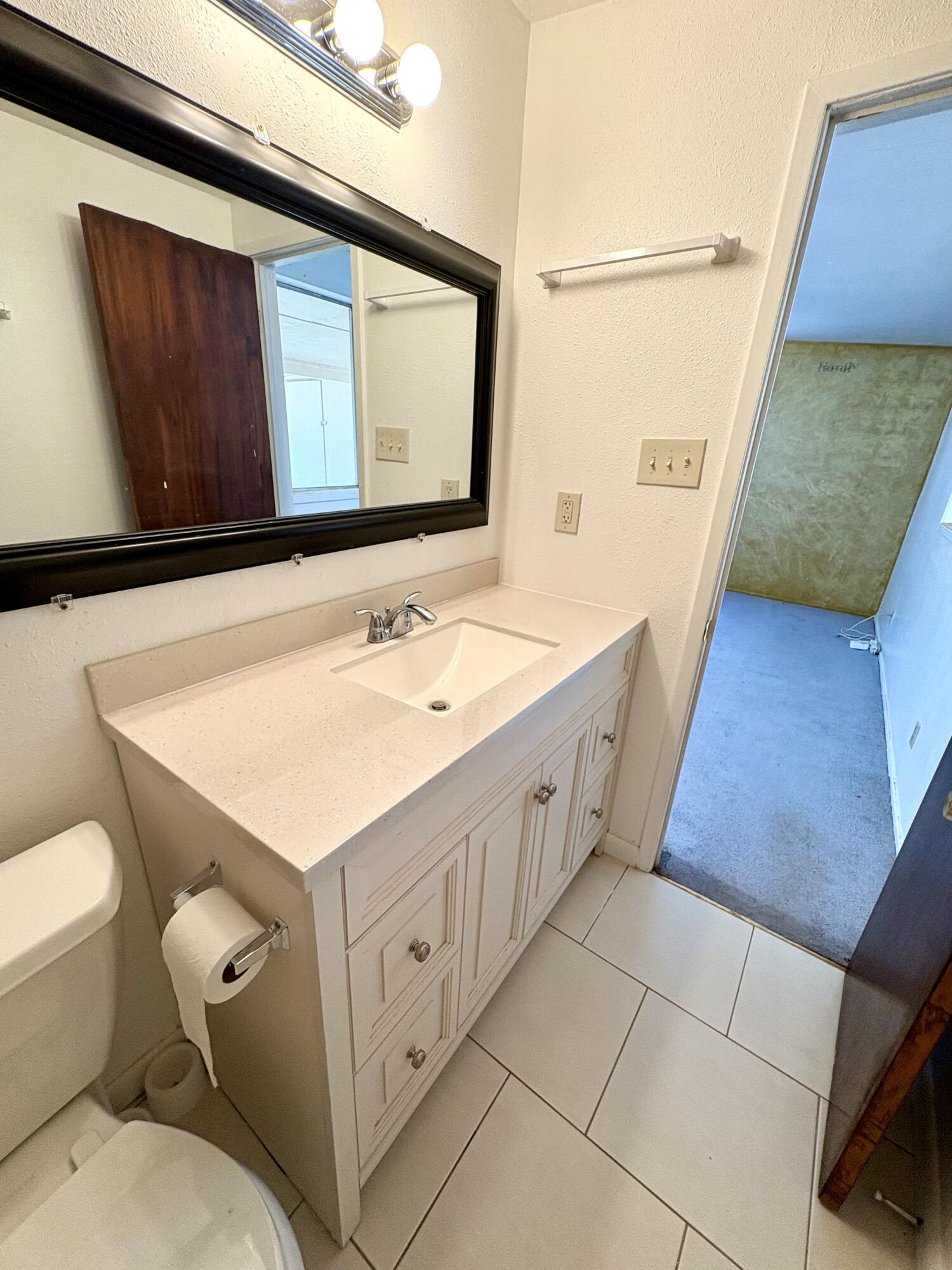 4618 44th Street Lubbock, TX 79414 - Photo 17 of 21 a bathroom with a sink a toilet and mirror