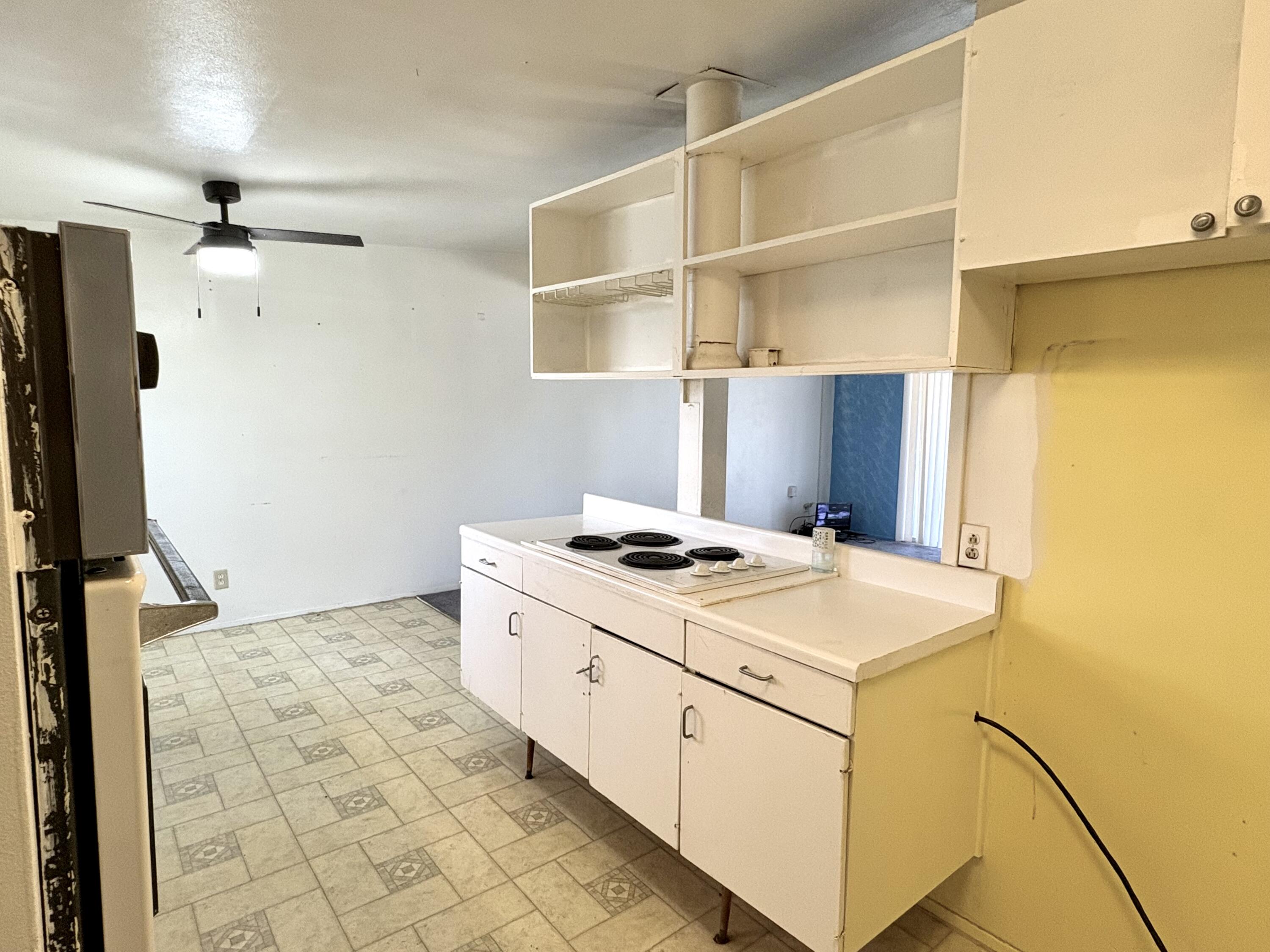 4618 44th Street Lubbock, TX 79414 - Photo 5 of 21 a kitchen with a stove a refrigerator and a cabinets