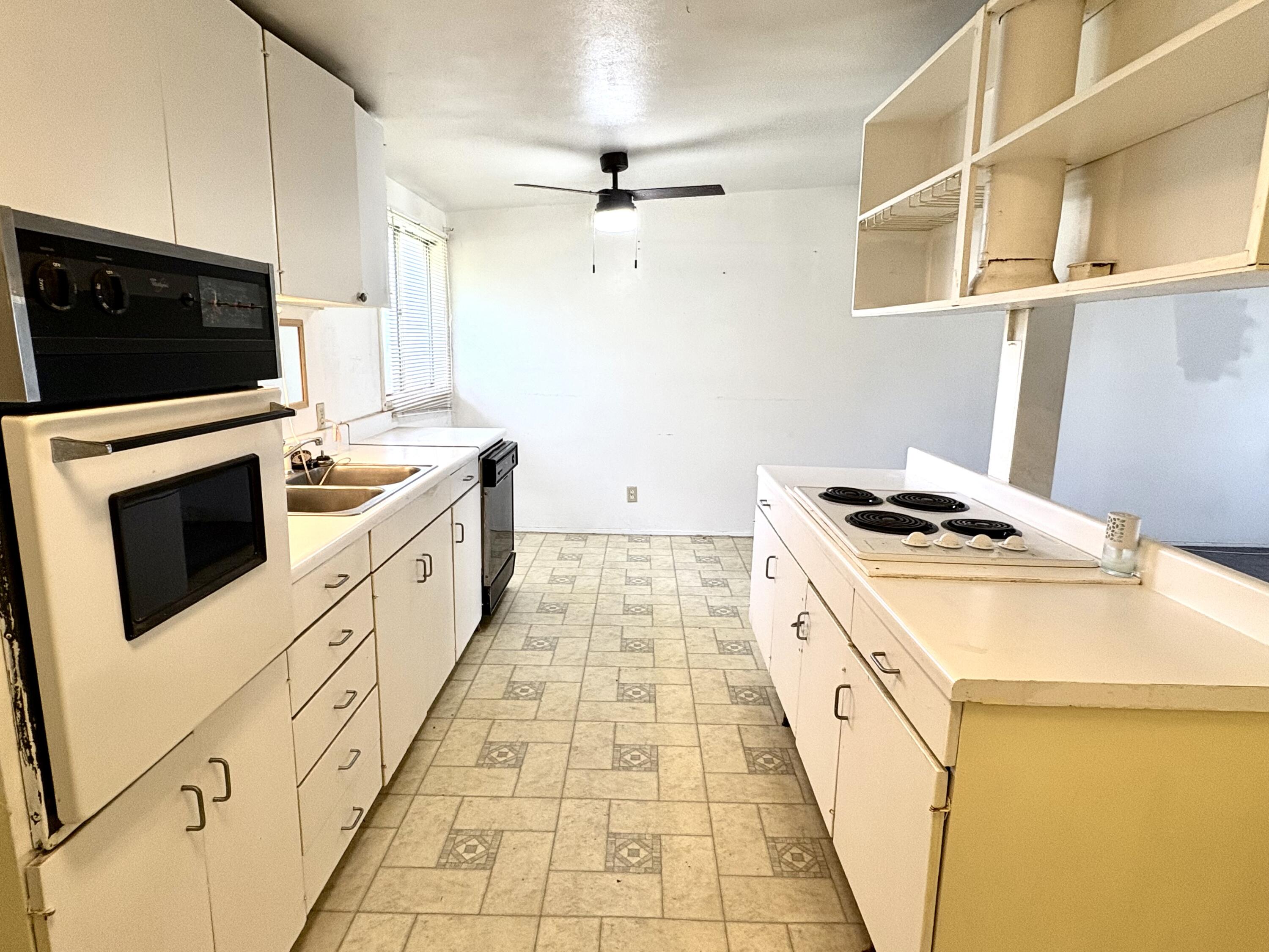 4618 44th Street Lubbock, TX 79414 - Photo 6 of 21 a kitchen with sink a stove and a microwave
