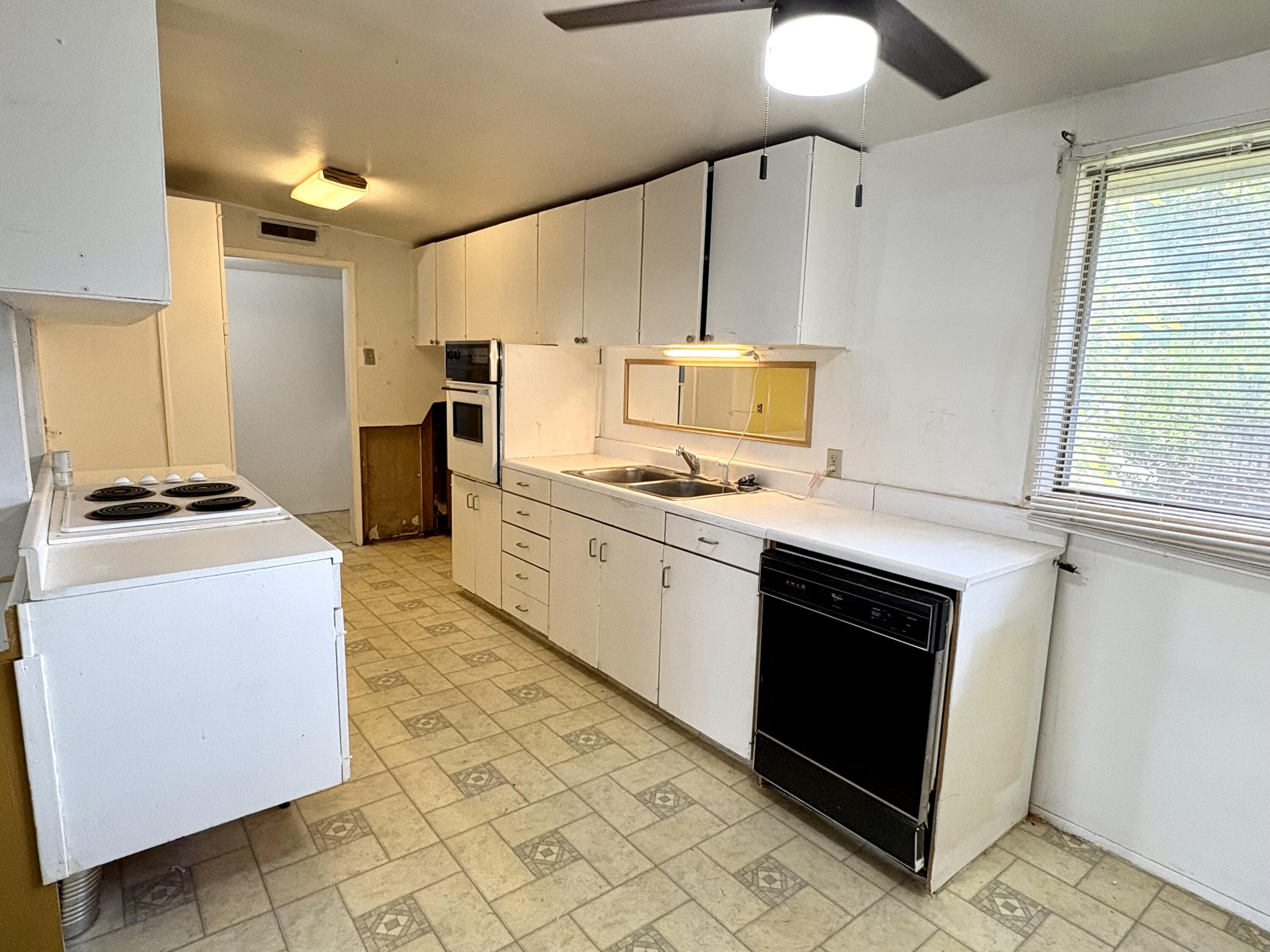 4618 44th Street Lubbock, TX 79414 - Photo 7 of 21 a kitchen with stainless steel appliances granite countertop a stove a sink and a microwave