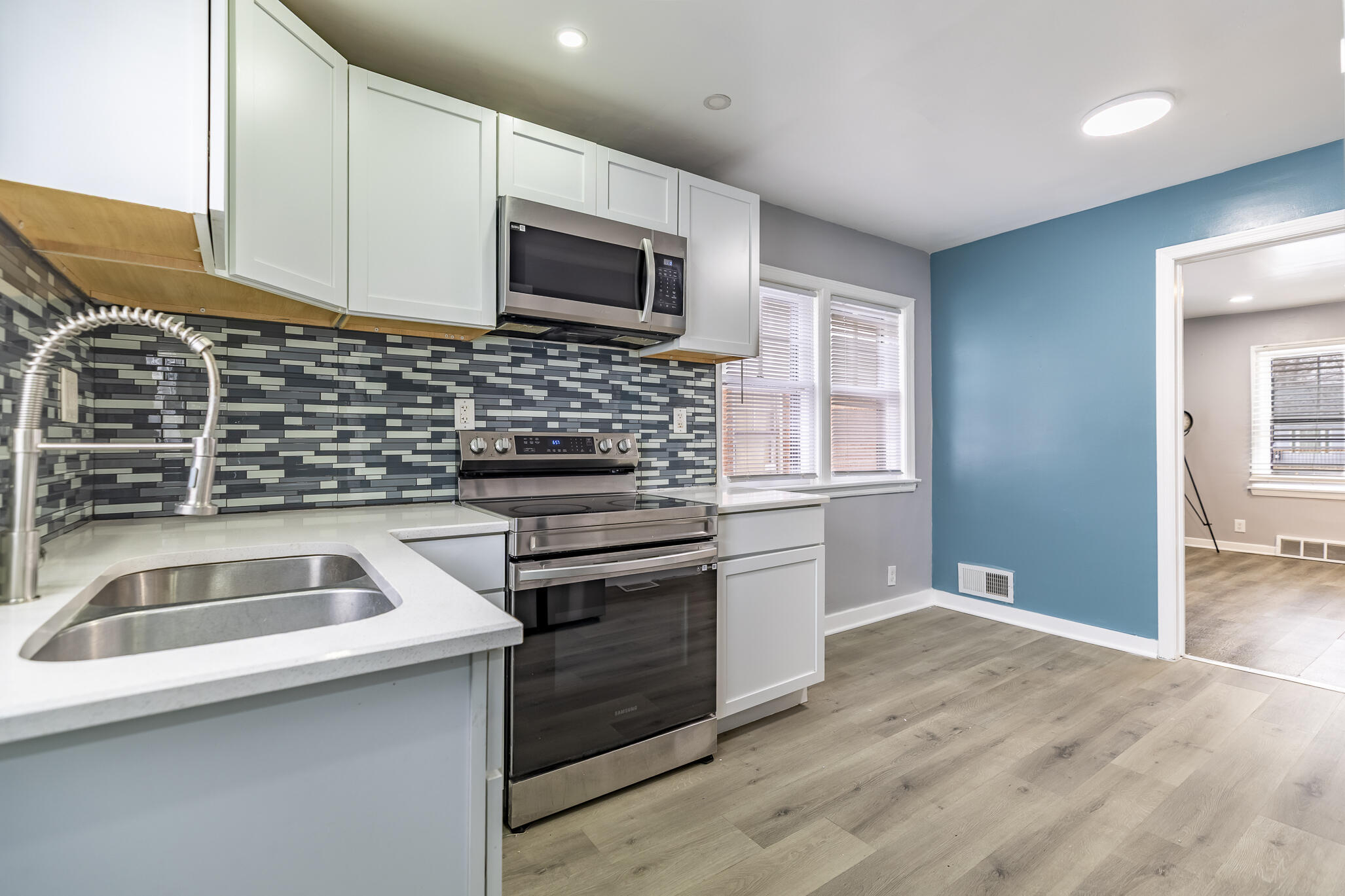4601 Buchanan Street Gary, IN 46408 - Photo 13 of 27 a kitchen that has a sink and a stove top oven