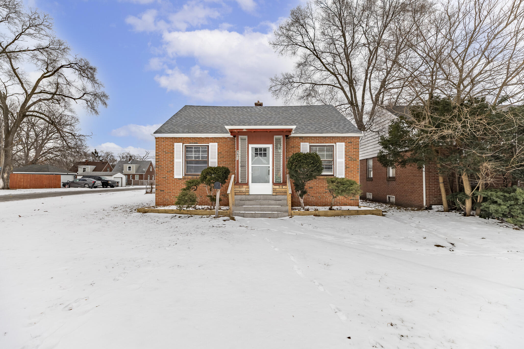 4601 Buchanan Street Gary, IN 46408 - Photo 2 of 27 a view of a house with a snow in a yard